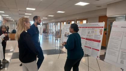 Faculty presenting research poster
