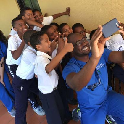 photo of children looking at cell phone